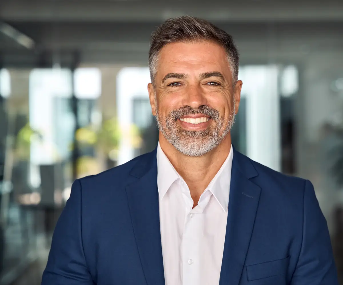A smiling man in a blazer